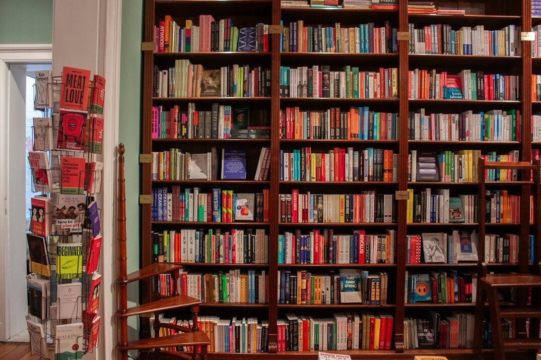 Quiet library with tall wooden shelves full of books