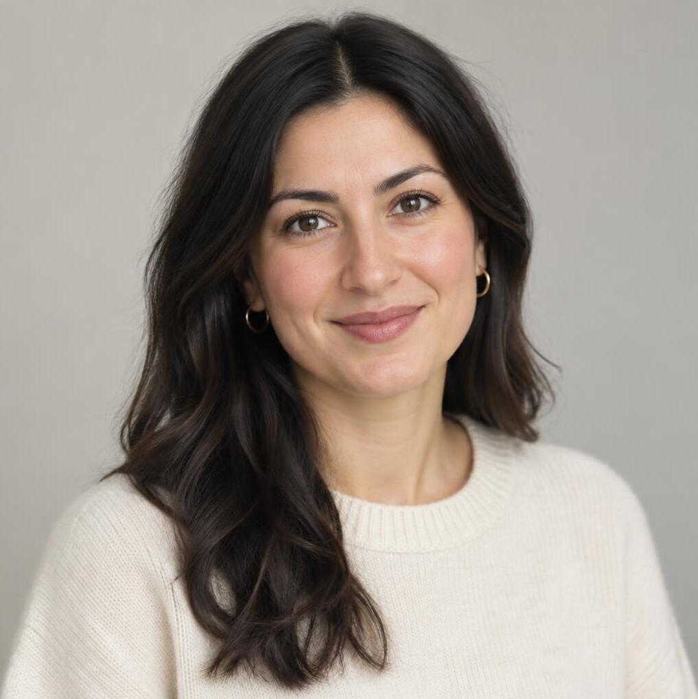 Portrait of a woman with dark hair smiling softly